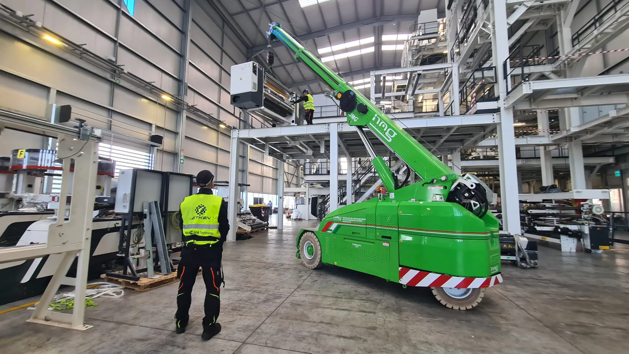 Indoor crane positioning machinery onto a mezzanine