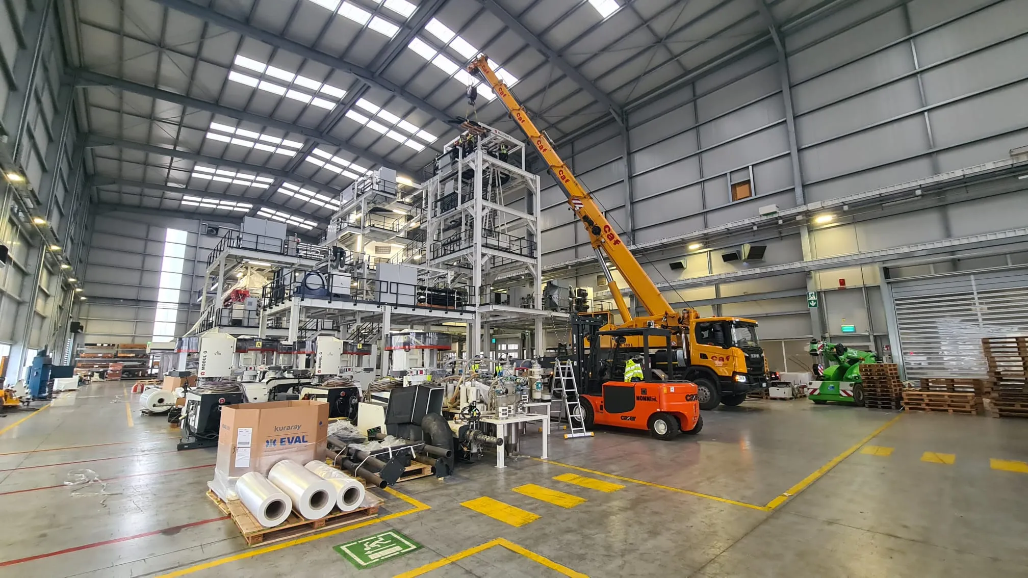 Multi-crew industrial assembly with crane, forklift and telehandler