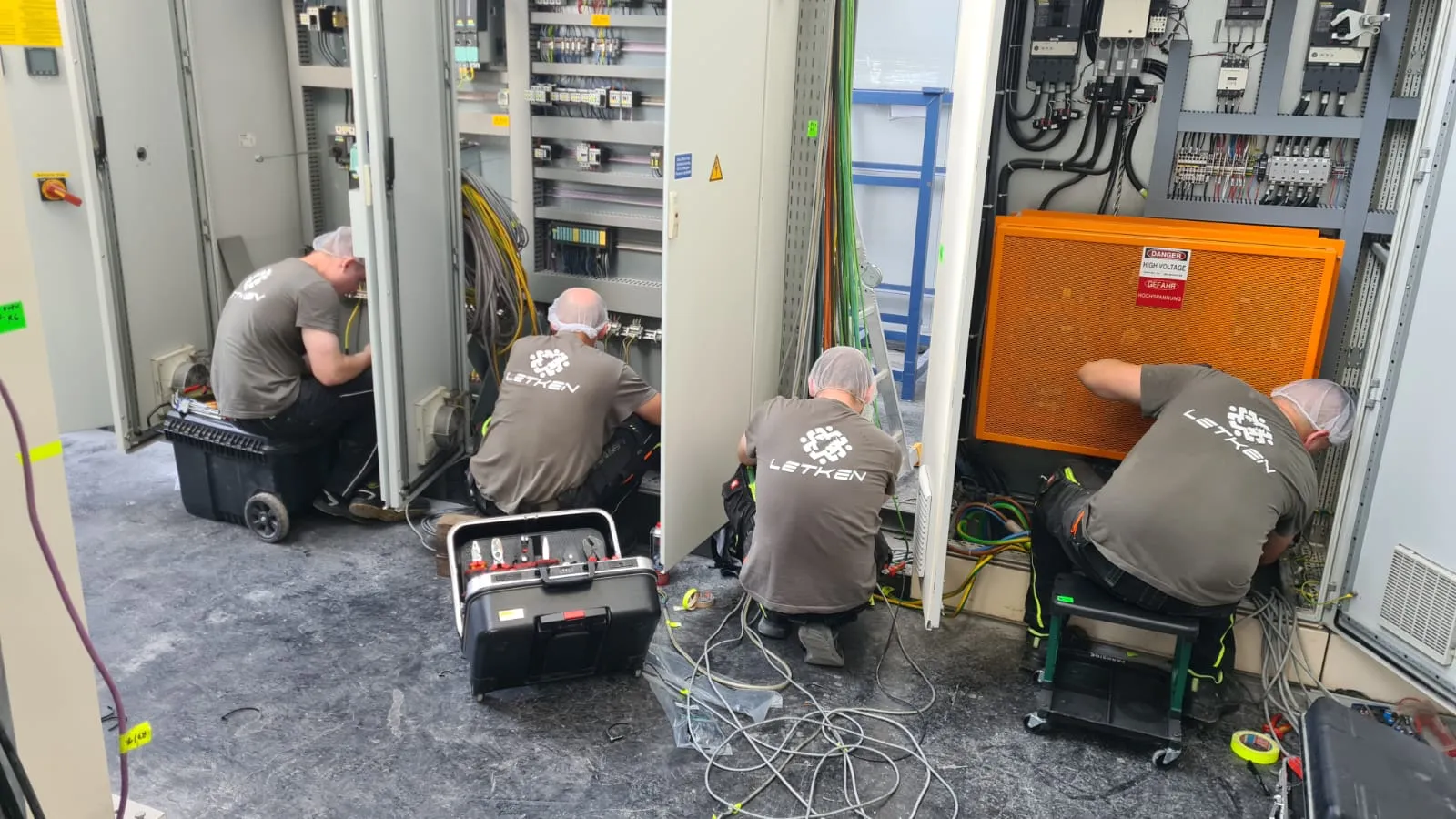 Team wiring industrial switchgear with high-voltage cabinets