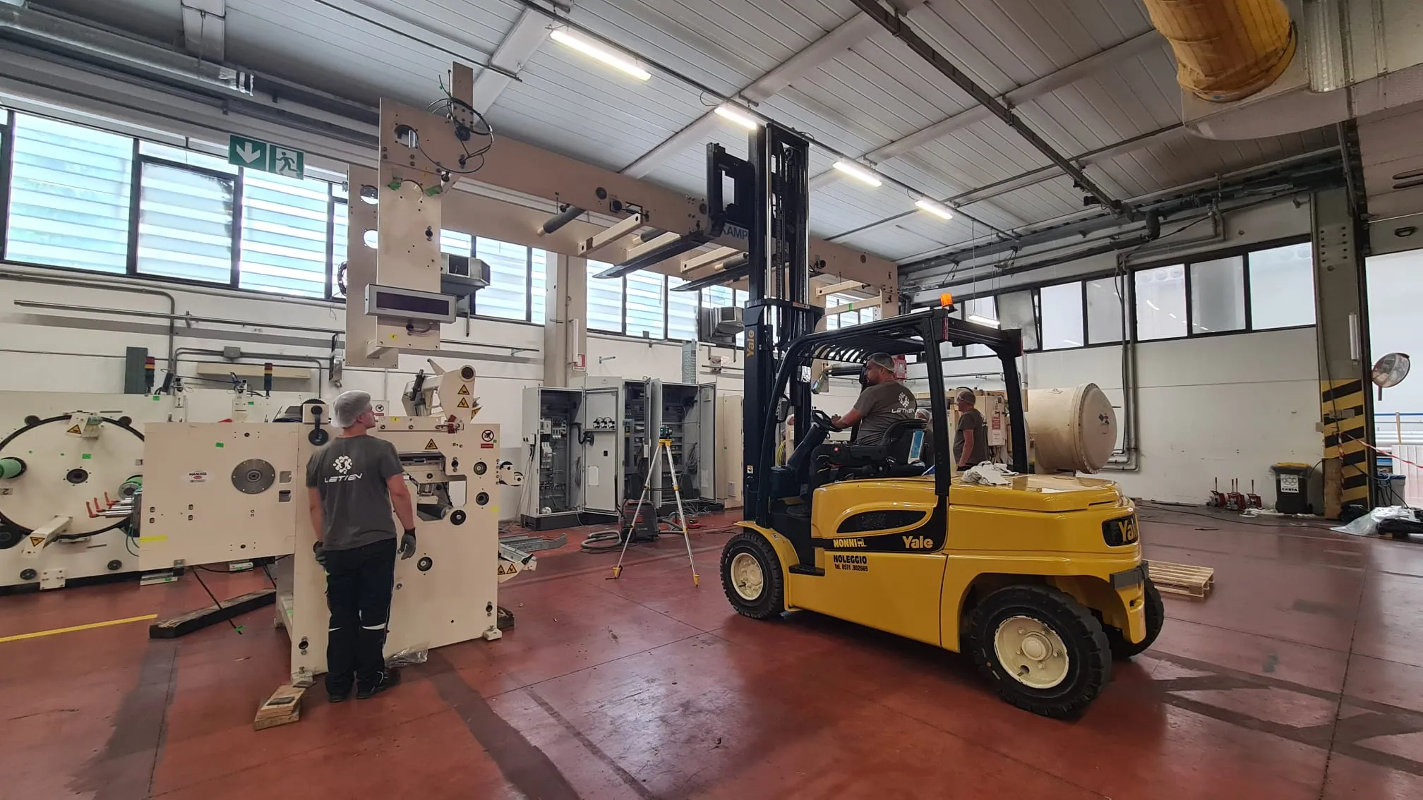 Forklift supporting a machine beam during alignment